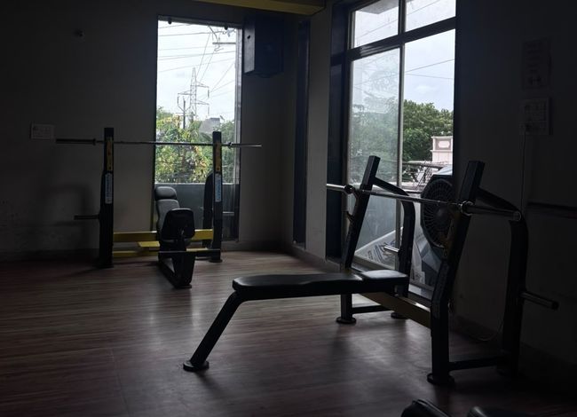 Olympic flat barbell bench press and multi-grip squat station at Tathhastu Fitness